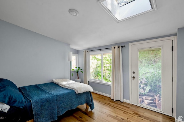 1155 N Pinecrest Canyon Rd, Salt Lake City, UT 84108 - bedroom featuring lofted ceiling, light wood-style flooring, a skylight, and access to outside