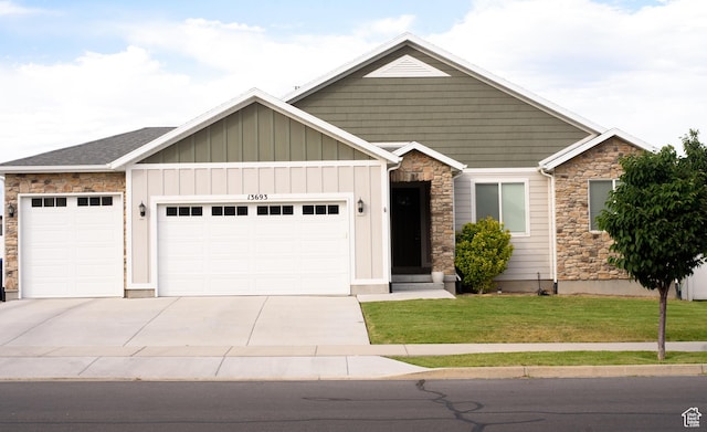 13693 S Blayde Dr, Herriman, UT 84096 - craftsman inspired home with stone siding, an attached garage, board and batten siding, a front yard, and driveway