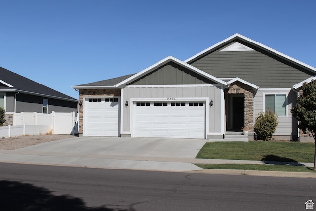 13693 S Blayde Dr, Herriman, UT 84096 - view of front of property with an attached garage, driveway, stone siding, and board and batten siding