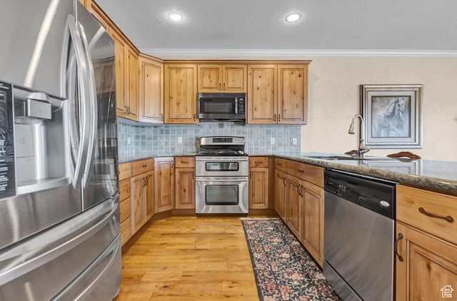 285 E Brayden Way, Draper, UT 84020 - kitchen featuring stainless steel appliances, dark stone counters, ornamental molding, light wood-type flooring, and tasteful backsplash