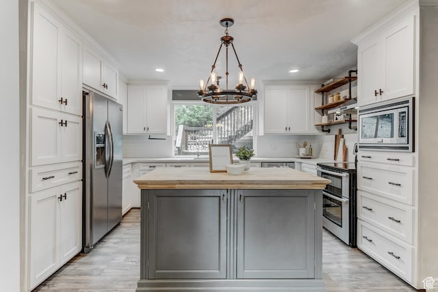 4831 E Emigration Canyon Rd, Salt Lake City, UT 84108 - kitchen with appliances with stainless steel finishes, a chandelier, wooden counters, open shelves, and light wood-type flooring