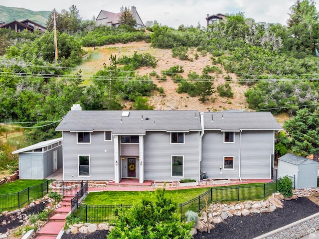 4831 E Emigration Canyon Rd, Salt Lake City, UT 84108 - back of house with a fenced backyard, a storage shed, a patio, and roof with shingles