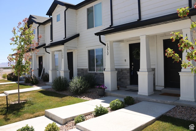 661 W 1920 S Unit 1070, Provo, UT 84601 - view of front facade with a porch, a front yard, and stone siding