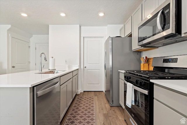 661 W 1920 S Unit 1070, Provo, UT 84601 - kitchen featuring stainless steel appliances, a peninsula, light wood-style floors, light countertops, and recessed lighting