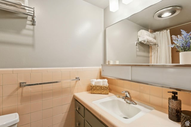 1112 E 2700 S Unit C17, Salt Lake City, UT 84106 - bathroom with vanity, tile walls, a shower with curtain, and a wainscoted wall