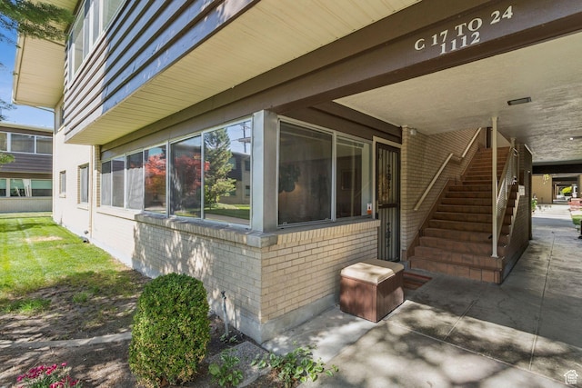 1112 E 2700 S Unit C17, Salt Lake City, UT 84106 - view of side of property featuring brick siding, stairs, and a patio area