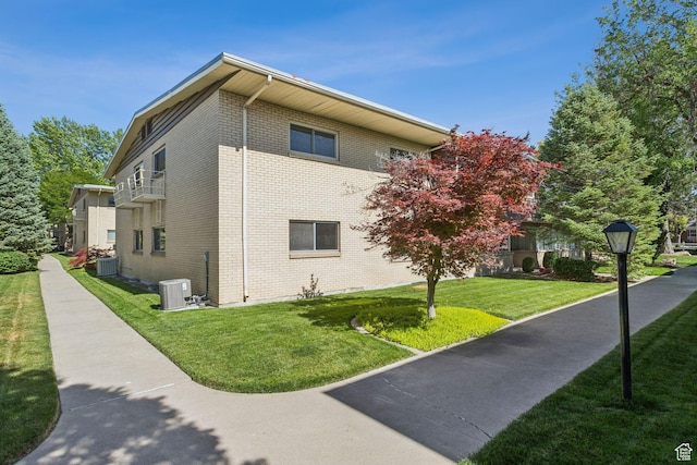 1112 E 2700 S Unit C17, Salt Lake City, UT 84106 - view of side of home featuring brick siding and a yard