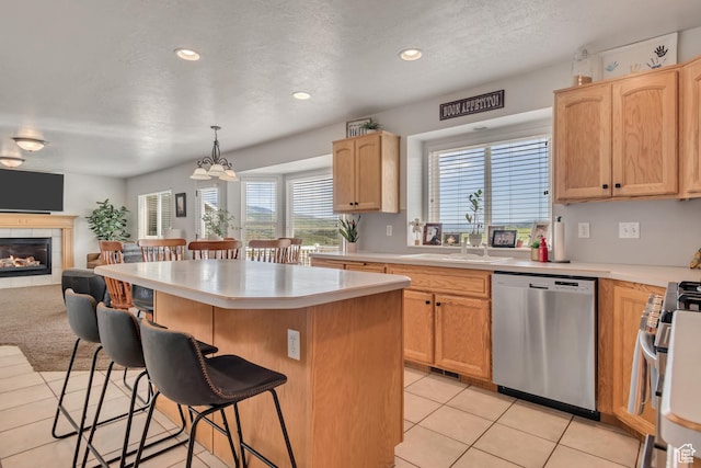 5149 W Rendezvous, Mountain Green, UT 84050 - kitchen featuring stainless steel appliances, a breakfast bar, a center island, open floor plan, and light countertops
