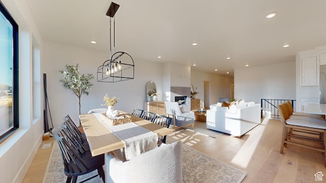 683 N Heritage St, Mapleton, UT 84664 - dining space with light wood-type flooring, recessed lighting, a chandelier, and a fireplace