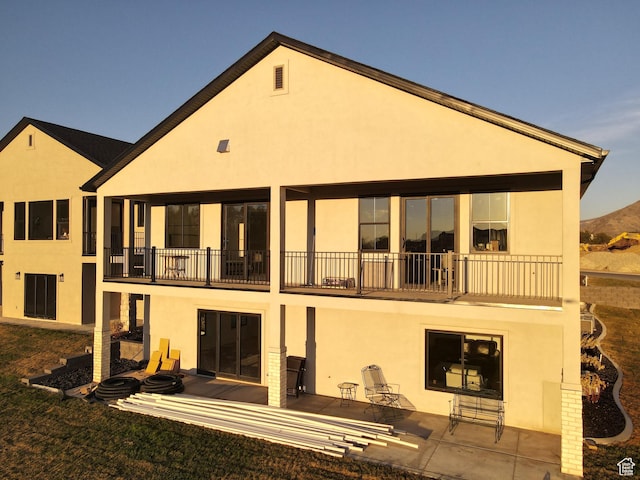 683 N Heritage St, Mapleton, UT 84664 - rear view of house featuring stucco siding and a balcony