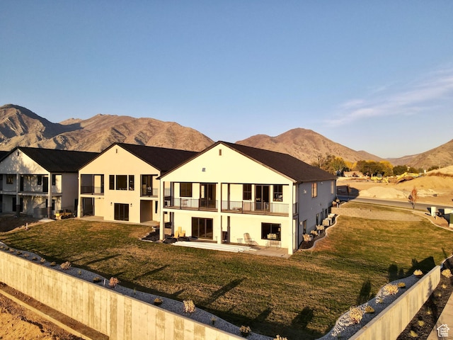 683 N Heritage St, Mapleton, UT 84664 - view of front facade with a balcony, a mountain view, a patio, and a front yard