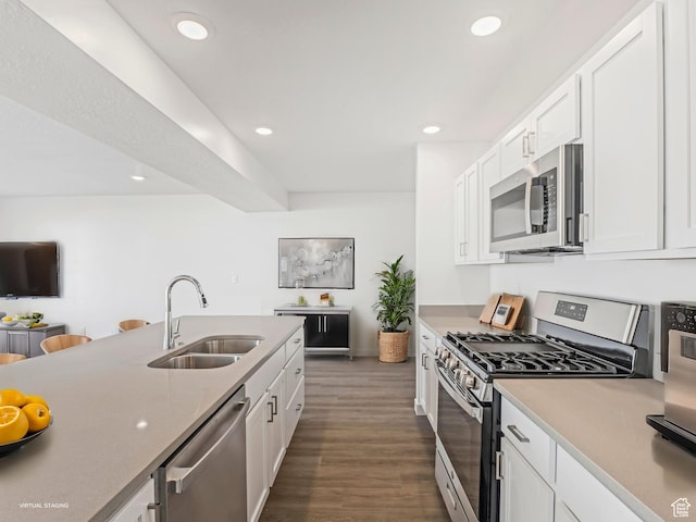 2392 E Woodbury Ln Unit 551, Eagle Mountain, UT 84005 - kitchen with stainless steel appliances, white cabinets, dark wood-type flooring, recessed lighting, and light countertops