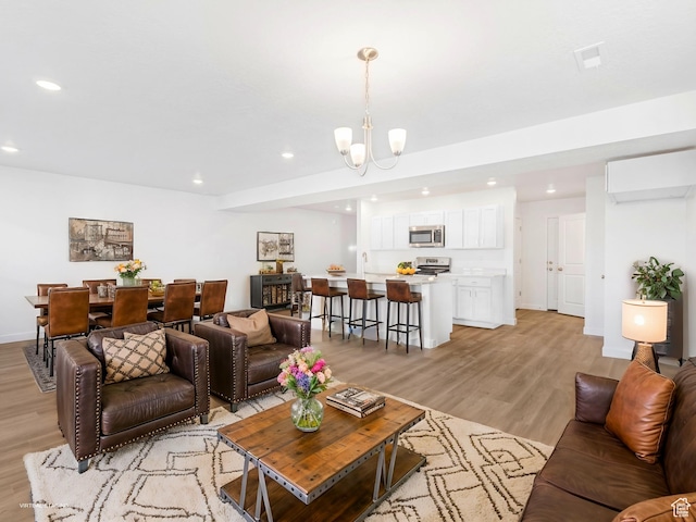 2392 E Woodbury Ln Unit 551, Eagle Mountain, UT 84005 - living room with recessed lighting, light wood-style floors, and a chandelier
