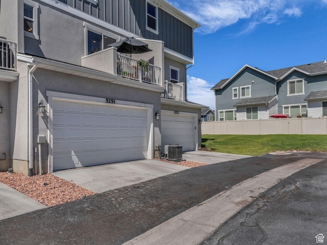5251 W Linley Ct, Herriman, UT 84096 - view of home's exterior featuring a garage, a balcony, stucco siding, and board and batten siding
