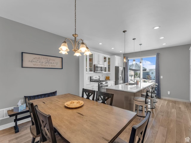 5251 W Linley Ct, Herriman, UT 84096 - dining space featuring light wood finished floors, recessed lighting, and a chandelier