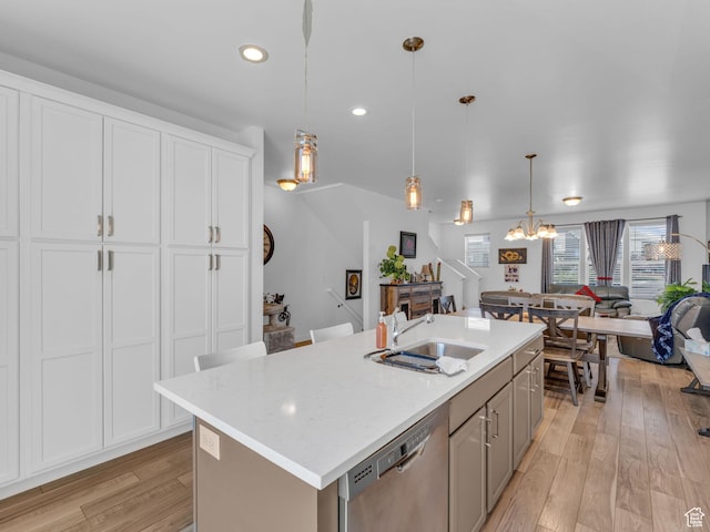 5251 W Linley Ct, Herriman, UT 84096 - kitchen with dishwasher, a chandelier, open floor plan, light wood-type flooring, and a kitchen island with sink