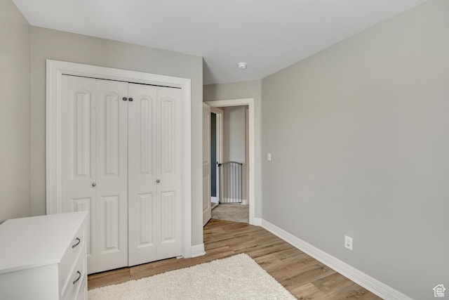 9209 N Prairie Dunes Way, Eagle Mountain, UT 84005 - unfurnished bedroom featuring light wood-style flooring and a closet