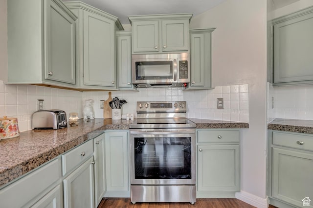 9209 N Prairie Dunes Way, Eagle Mountain, UT 84005 - kitchen with stainless steel appliances, green cabinets, tasteful backsplash, and wood finished floors