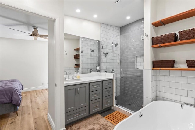 1543 E Spring Run Dr, Salt Lake City, UT 84117 - bathroom featuring a shower stall, vanity, a soaking tub, ceiling fan, and wood finished floors
