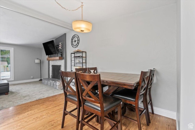1543 E Spring Run Dr, Salt Lake City, UT 84117 - dining space featuring a large fireplace and light wood-style floors