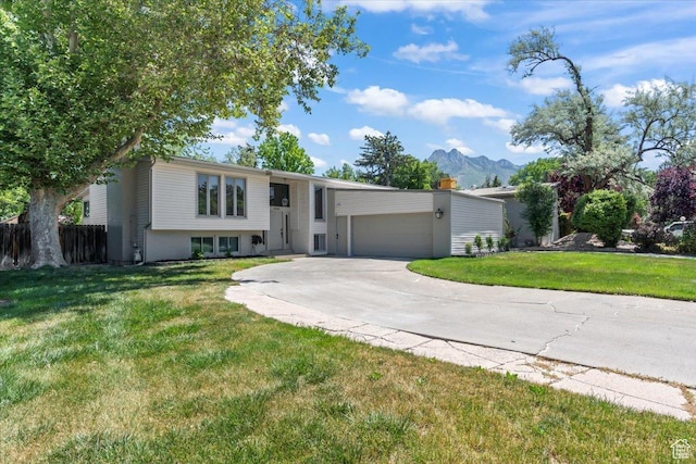 1543 E Spring Run Dr, Salt Lake City, UT 84117 - raised ranch with concrete driveway, a garage, and a mountain view