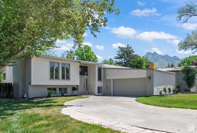 1543 E Spring Run Dr, Salt Lake City, UT 84117 - split foyer home with a mountain view, a front lawn, an attached garage, and concrete driveway