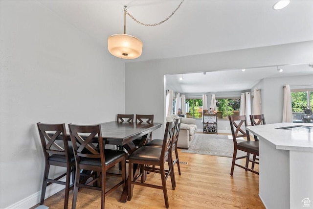 1543 E Spring Run Dr, Salt Lake City, UT 84117 - dining space with light wood-style flooring and baseboards