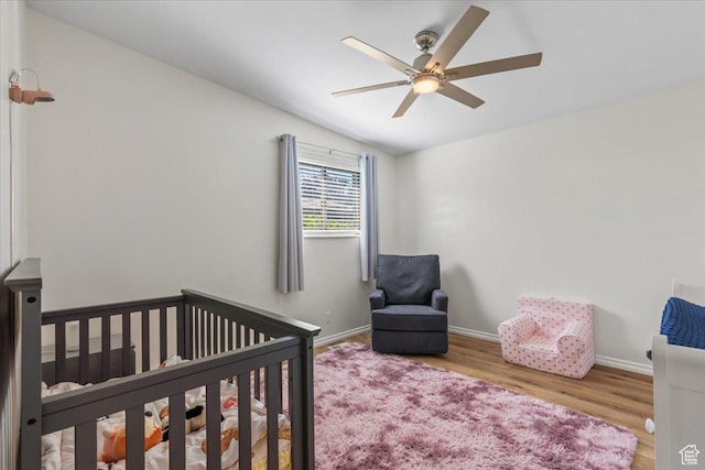 1543 E Spring Run Dr, Salt Lake City, UT 84117 - bedroom with a nursery area, wood finished floors, and ceiling fan
