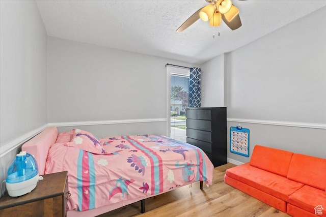 1543 E Spring Run Dr, Salt Lake City, UT 84117 - bedroom with wood finished floors, a ceiling fan, a textured ceiling, and access to outside