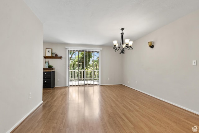 2522 E 1950 N, Layton, UT 84040 - empty room with a chandelier and light wood-style flooring