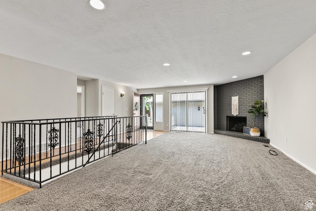 2522 E 1950 N, Layton, UT 84040 - spare room with a textured ceiling, carpet floors, a fireplace, and recessed lighting