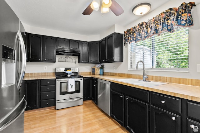 2522 E 1950 N, Layton, UT 84040 - kitchen with appliances with stainless steel finishes, dark cabinets, ceiling fan, under cabinet range hood, and light countertops