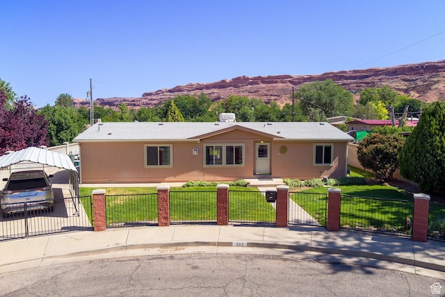466 W Wingate Ave, Moab, UT 84532 - single story home with a fenced front yard, a mountain view, and a gate