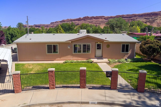 466 W Wingate Ave, Moab, UT 84532 - single story home with a fenced front yard, a mountain view, and a gate