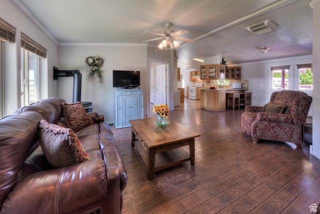 466 W Wingate Ave, Moab, UT 84532 - living room featuring a wood stove, crown molding, dark wood finished floors, ceiling fan, and french doors