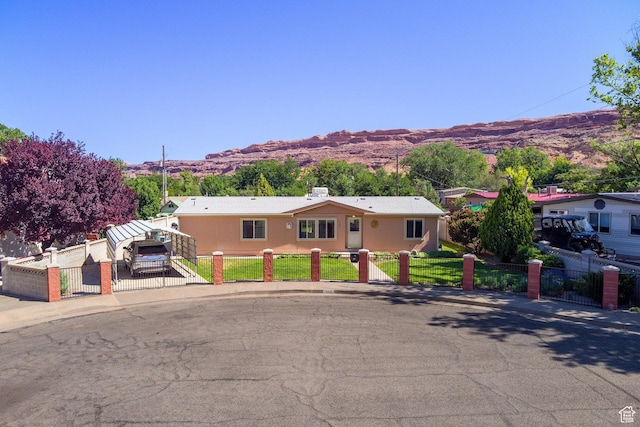 466 W Wingate Ave, Moab, UT 84532 - ranch-style house featuring a mountain view, a fenced front yard, and a gate