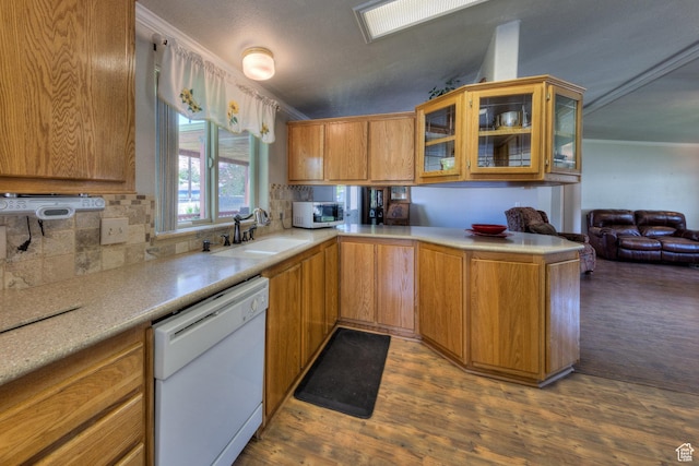 466 W Wingate Ave, Moab, UT 84532 - kitchen featuring dishwasher, backsplash, light countertops, wood finished floors, and glass insert cabinets