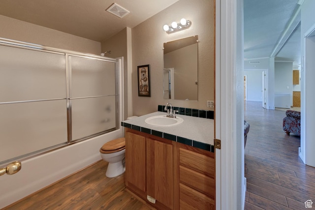 466 W Wingate Ave, Moab, UT 84532 - full bath with wood finished floors, vanity, and enclosed tub / shower combo