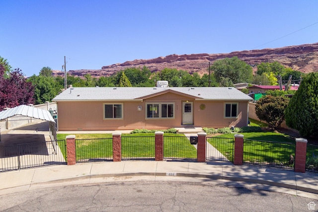 466 W Wingate Ave, Moab, UT 84532 - ranch-style home with a mountain view, a fenced front yard, and a gate