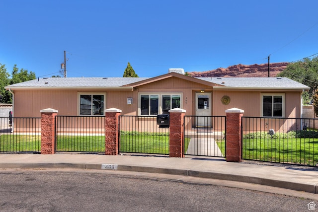 466 W Wingate Ave, Moab, UT 84532 - view of front of home with a fenced front yard and roof with shingles