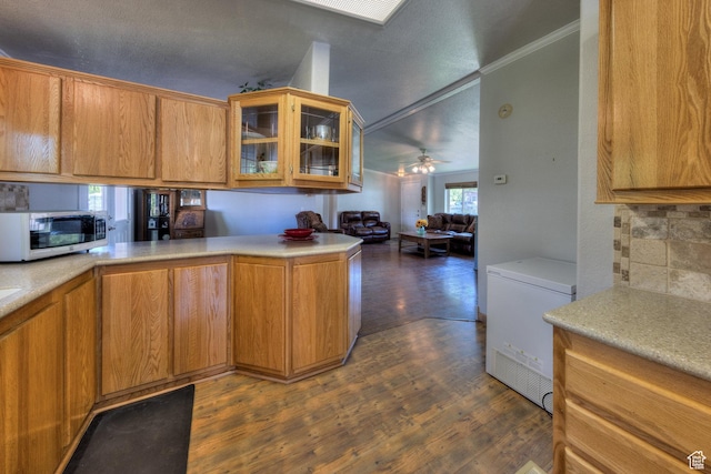 466 W Wingate Ave, Moab, UT 84532 - kitchen featuring stainless steel microwave, refrigerator, light countertops, glass insert cabinets, and ornamental molding