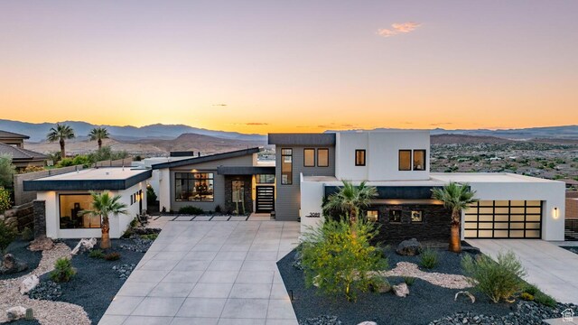 3089 E Banded Hills Dr, St George, UT 84790 - contemporary house with a mountain view, driveway, a garage, and stucco siding