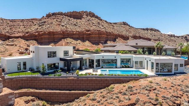 3089 E Banded Hills Dr, St George, UT 84790 - back of house with stucco siding, a mountain view, a patio area, and an outdoor pool