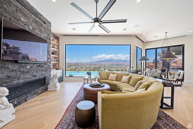 3089 E Banded Hills Dr, St George, UT 84790 - living area featuring wood-type flooring, a fireplace, ceiling fan, built in shelves, and recessed lighting