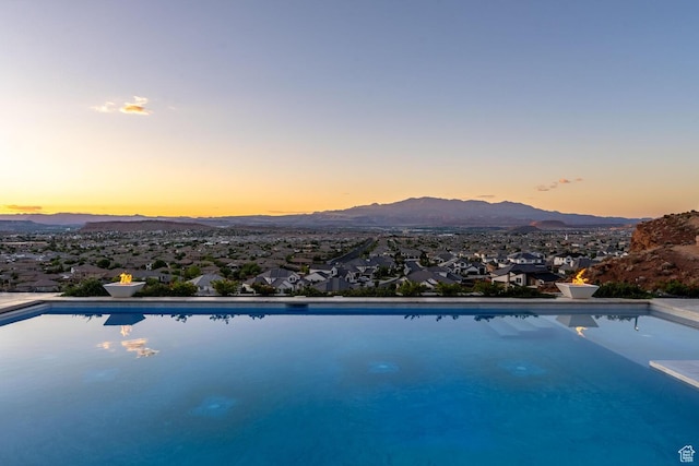 3089 E Banded Hills Dr, St George, UT 84790 - pool at dusk with a mountain view and an outdoor pool