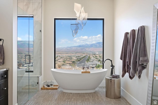 3089 E Banded Hills Dr, St George, UT 84790 - full bathroom featuring a soaking tub, vanity, and tile patterned floors