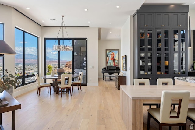 3089 E Banded Hills Dr, St George, UT 84790 - dining room with a chandelier, light wood-style flooring, recessed lighting, and a mountain view