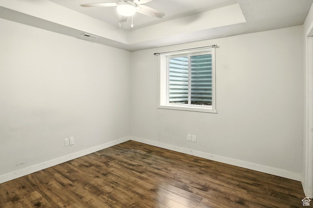 5254 W Burntside Ave, South Jordan, UT 84009 - empty room with a tray ceiling, ceiling fan, and dark wood-type flooring