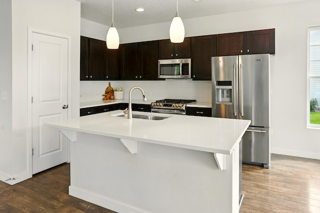 5254 W Burntside Ave, South Jordan, UT 84009 - kitchen featuring stainless steel appliances, hardwood / wood-style floors, light countertops, and backsplash