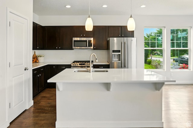 5254 W Burntside Ave, South Jordan, UT 84009 - kitchen with stainless steel appliances, dark wood-type flooring, light countertops, an island with sink, and recessed lighting